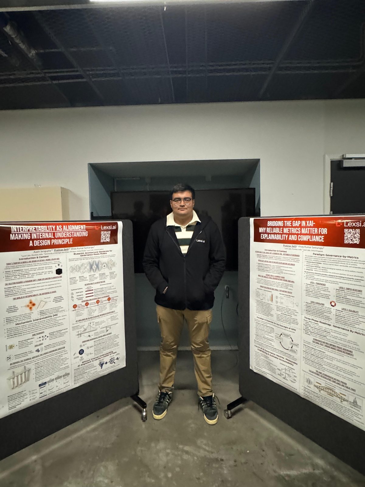 Pratinav Seth between two posters, Interpretability as Alignment and Bridging the Gap in XAI, at the EurIPS Workshop on Private AI Governance 2025