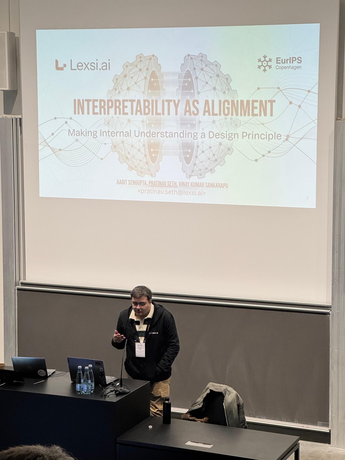 Pratinav Seth delivering the Interpretability as Alignment spotlight talk at the EurIPS Workshop on Private AI Governance, Copenhagen